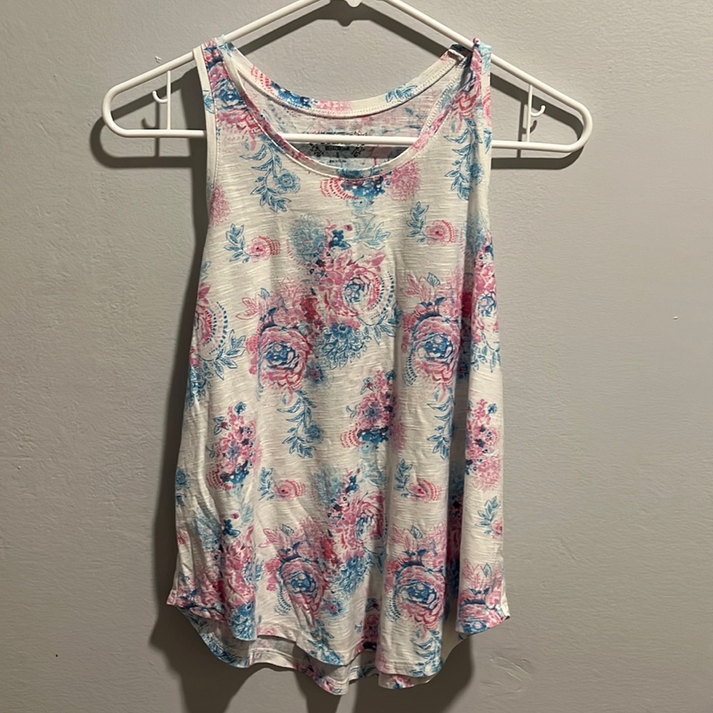 a white tank top with floral prints. Size small in juniors from Mudd.